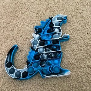 I’m selling a perfect no holes or colors no marks Godzilla pop it